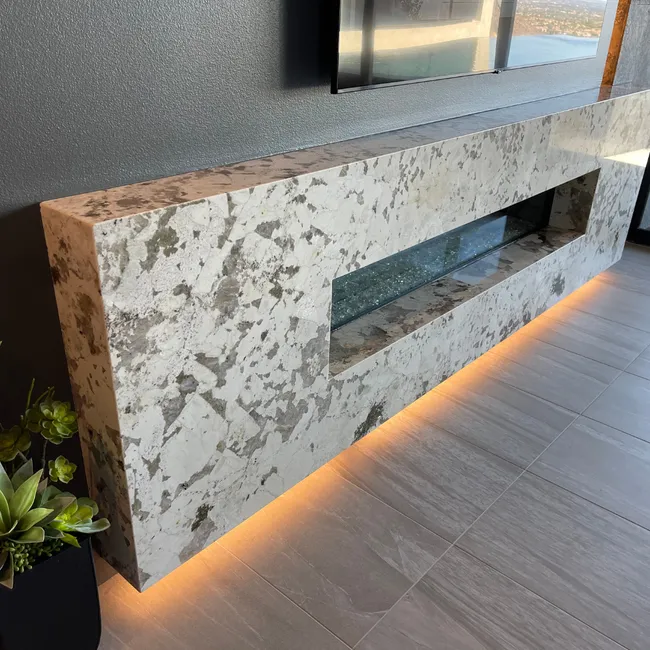 Elegant custom stone fireplace with a sleek design and ambient lighting