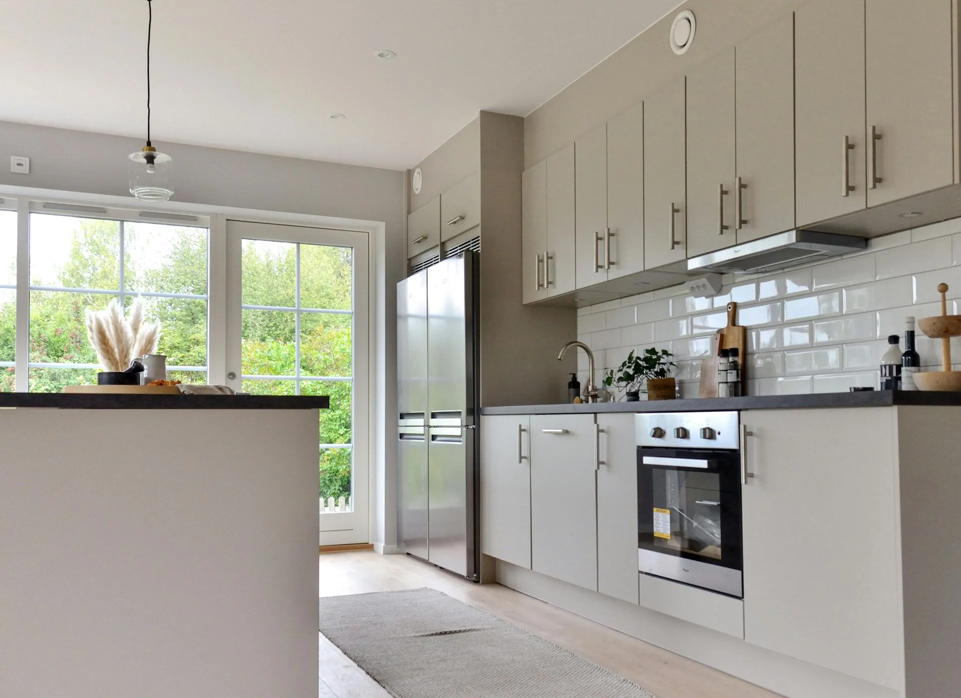 Kitchen cabinetry and shelving paired with stone surfaces